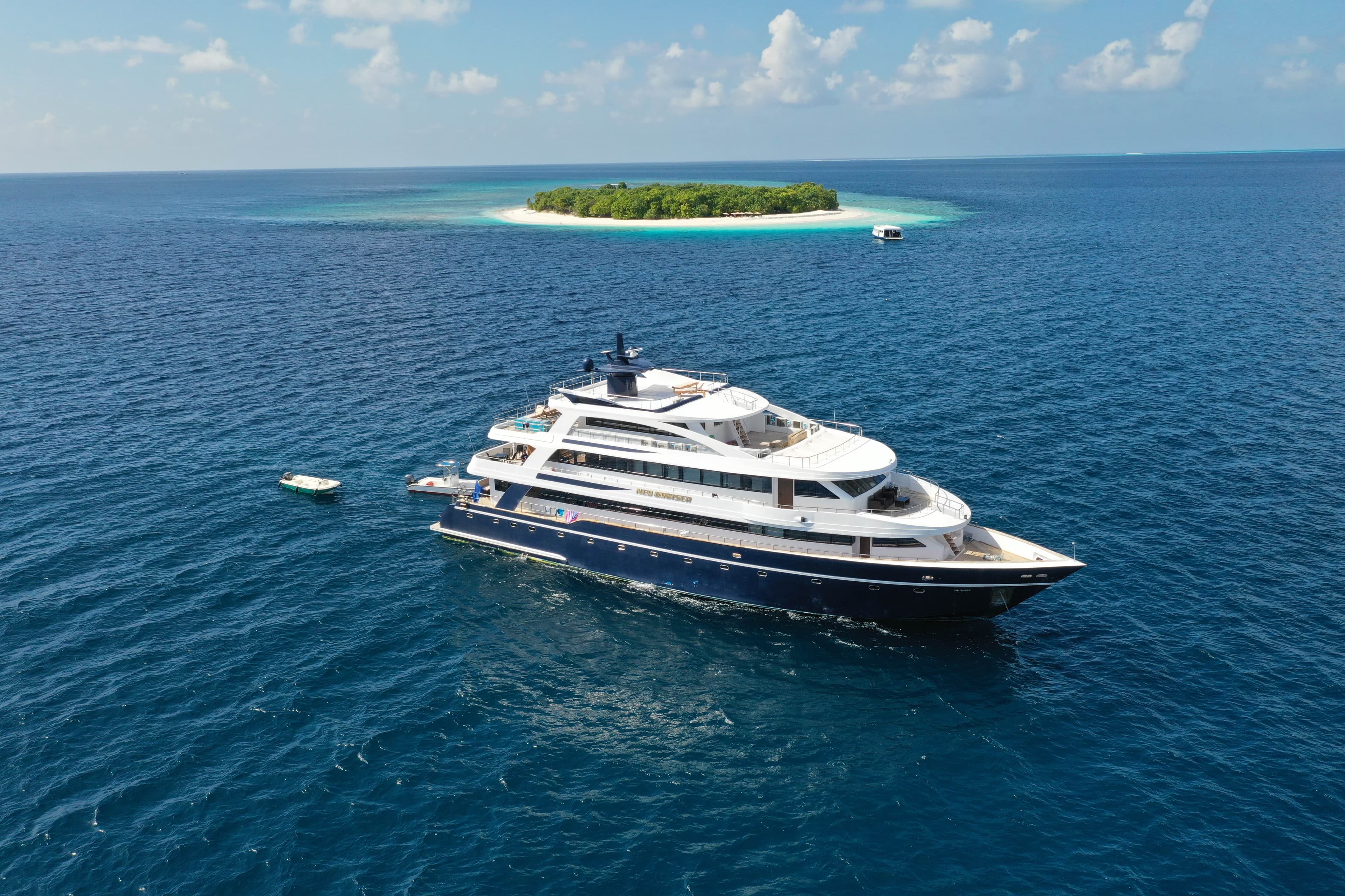 Aerial view of overwater villas in a turquoise Maldivian lagoon
